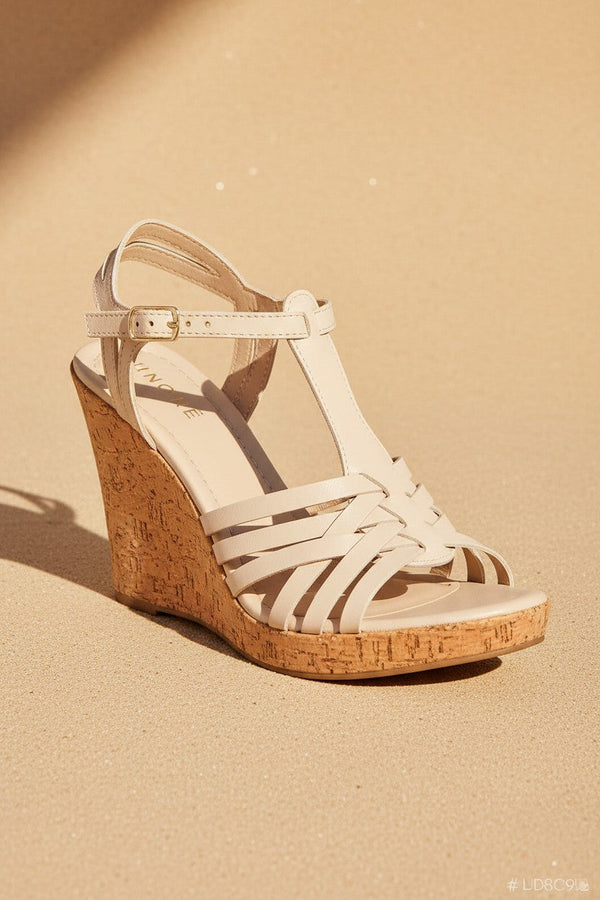André sandales compensées beige en cuir tressé, semelle liège, bride cheville réglable, talon 9cm, fabriquées en Italie.