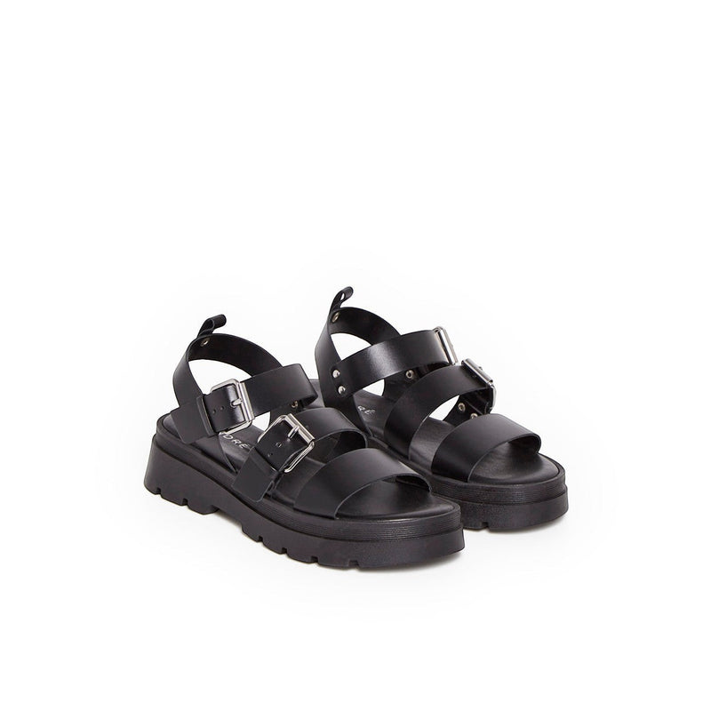 Sandales André Adonis en cuir noir avec brides à boucles et semelle plateforme crantée pour un look estival tendance