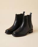 Boots CHAMPAGNE noir debout sur fond beige