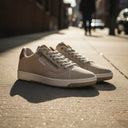 André Gobat beige suede sneakers with camel heel and tongue details and side zip.