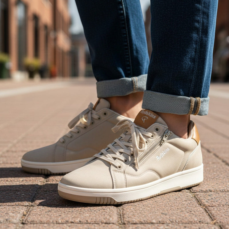 André Gobat beige suede sneakers with camel heel and tongue details, side zip, and white soles.
