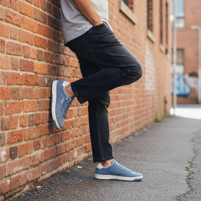 André Gobat blue denim sneakers with side zip and white sole. Casual urban style.