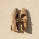 André sable suede ballet flats with double buckle straps. Soft leather, comfortable for daily wear.