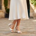 André white leather block heel sandals with ankle strap and square toe. Elegant and feminine design with a 9cm heel.