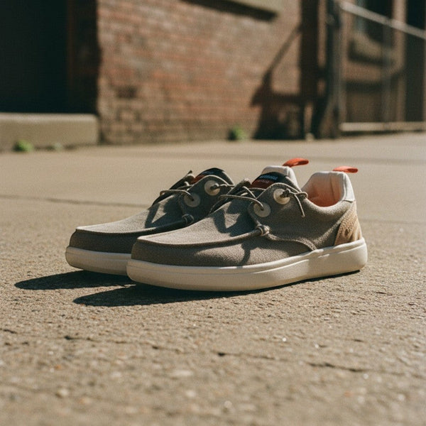 André Kibris kaki canvas and suede low-top sneakers with orange heel tabs and white soles.