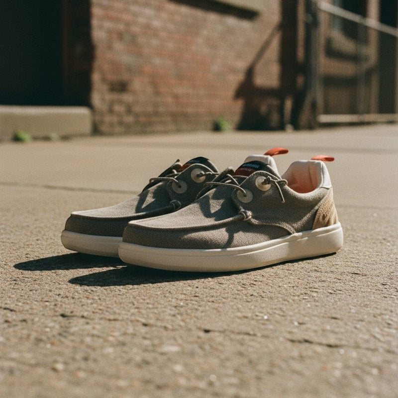 André Kibris kaki canvas and suede low-top sneakers with orange heel tabs and white soles.