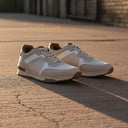 André Ladol II beige and camel suede, synthetic leather, and mesh running sneakers with a white midsole and brown outsole.