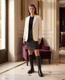 Botte LALIE noire portée avec un blazer écru dans un lobby d'hôtel — André