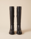 Paire de bottes LALIE noires debout sur fond beige