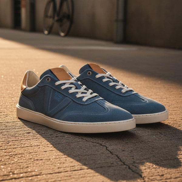 André Quadra Jean blue denim sneakers with camel leather accents and white laces. Suede and synthetic upper with rubber sole.