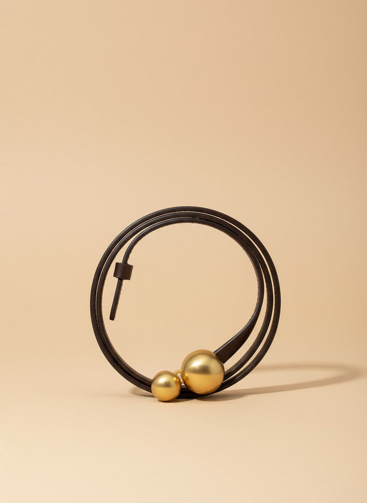 André brown leather belt with double gold ball buckle, ideal for cinching waists on jeans or blazers.